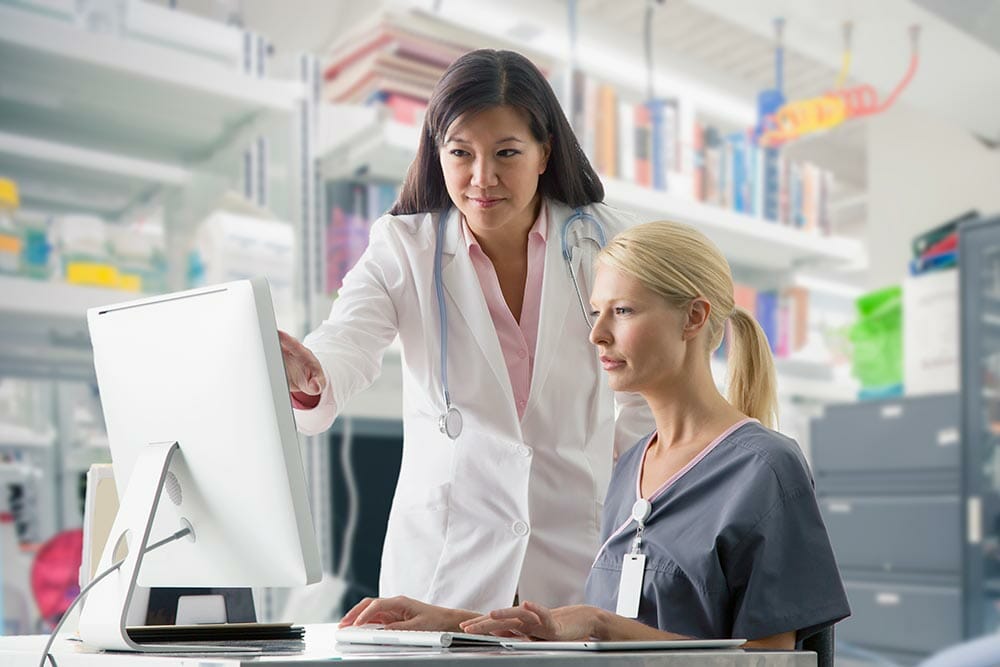 health workers on computer